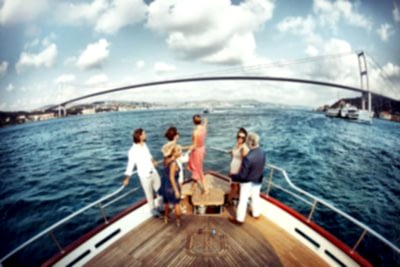 5 friends having a bosphorus cruise tour at Bosphorus sea of Istanbul